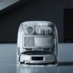 Smart Home Nightmare: How One Man Accessed Thousands of DJI Romo Robot Vacuums Globally 2 A DJI Romo robot vacuum in its translucent charging dock, highlighting its sleek design.