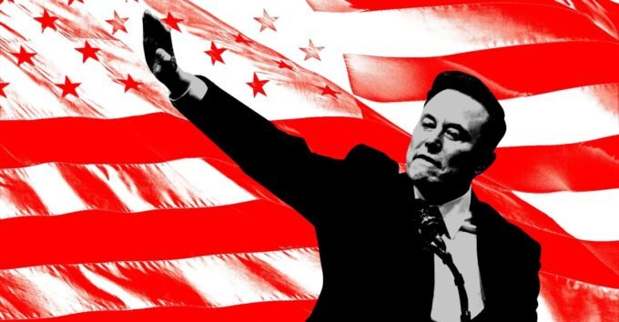 Elon Musk speaking at a press conference, with a blurred American flag in the background, symbolizing his involvement in political action.