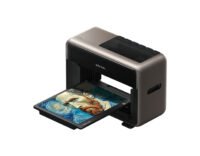 The eufyMake E1 UV Printer in a home workshop, showcasing its compact design and the vibrant results of its 3D texture printing capability.