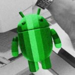 A hand holding an Android smartphone, scanning a document placed on a well-lit desk, with the FairScan app interface visible.