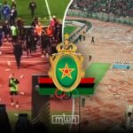 FAR Rabat players being escorted by security personnel after objects were thrown by Al Ahly fans in Cairo