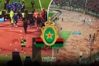 FAR Rabat players being escorted by security personnel after objects were thrown by Al Ahly fans in Cairo
