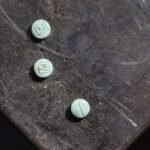 Explosive Claims: FBI Informant Accused of Enabling Deadly Dark Web Fentanyl Trade 4 Illustration of a dark web marketplace logo with a stylized FBI badge and fentanyl pills, symbolizing the controversial involvement of an FBI informant in illegal drug sales.