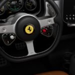 Interior view of the Ferrari Luce electric supercar, showcasing Jony Ive's design with multiple screens, physical buttons, and premium materials like Gorilla Glass and aluminum.