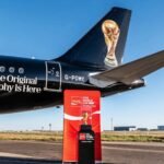 The FIFA World Cup Trophy on display at the Mohammed VI Football Complex in Salé, Morocco, surrounded by fans and officials.