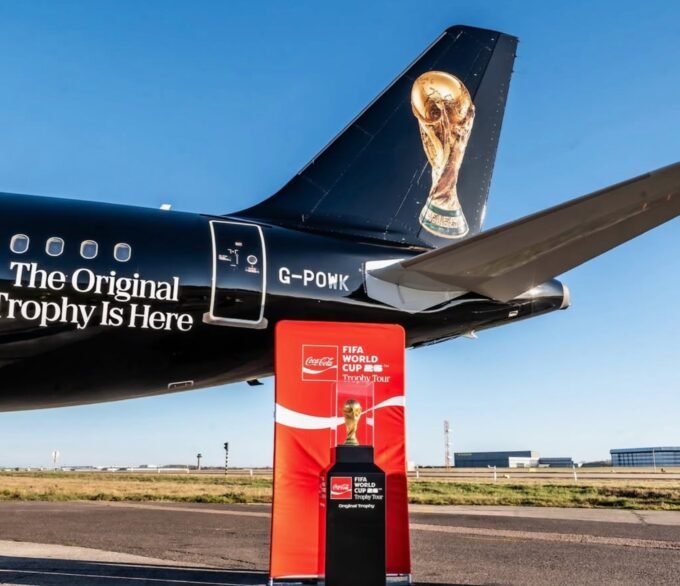 The FIFA World Cup Trophy on display at the Mohammed VI Football Complex in Salé, Morocco, surrounded by fans and officials.