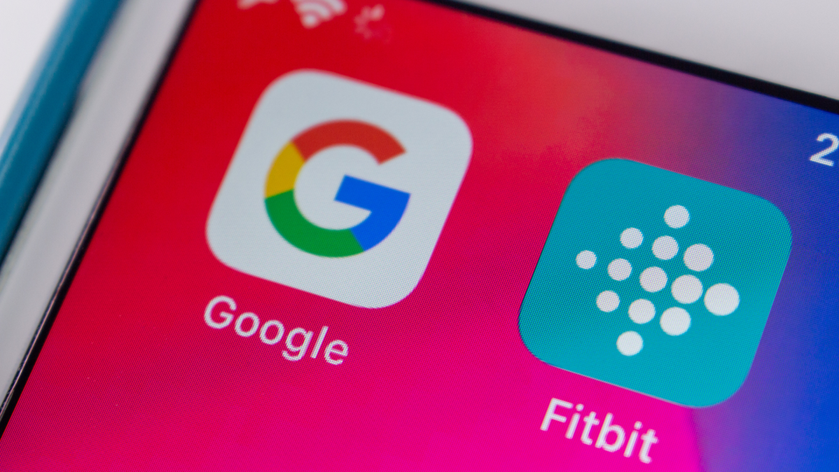 A Fitbit device screen displaying a Google account migration prompt, symbolizing the integration of health data.
