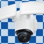 A modern floodlight security camera illuminating a dark outdoor area at night, providing both light and surveillance.