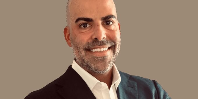 Florida's Corporate Evolution: The Rise of Florida Man 2.0 5 Mike Simas, president of The Florida Council of 100, standing in a modern office setting, symbolizing Florida's economic transformation and corporate appeal.