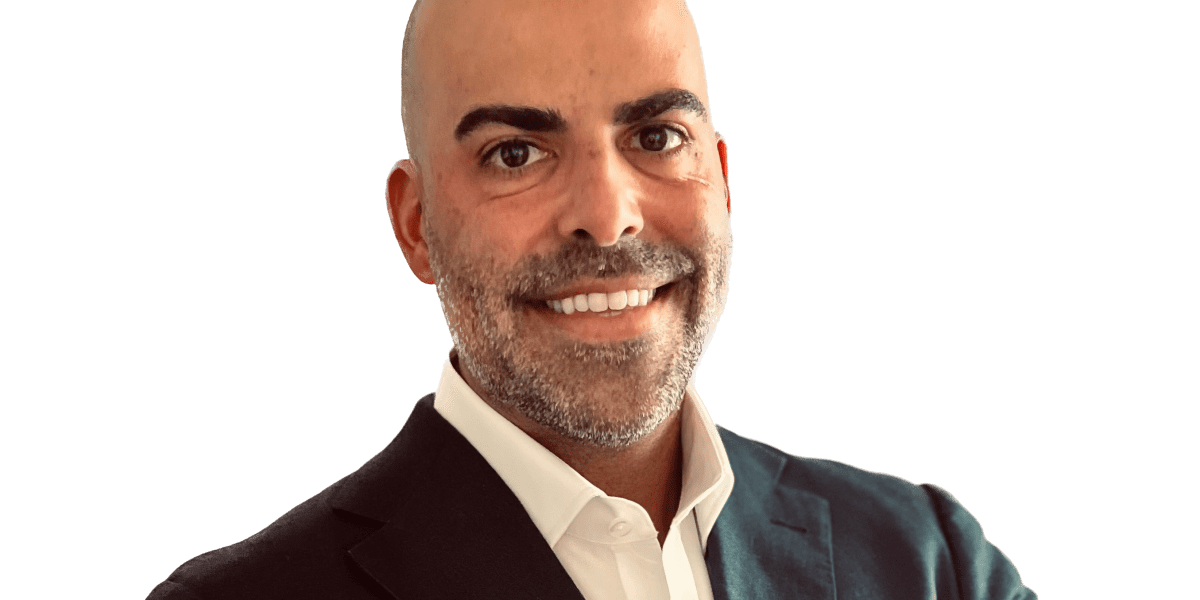 Mike Simas, president of The Florida Council of 100, standing in a modern office setting, symbolizing Florida's economic transformation and corporate appeal.