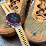 A close-up of a Garmin smartwatch screen displaying gear tracking data, possibly showing different running shoes assigned to activities.