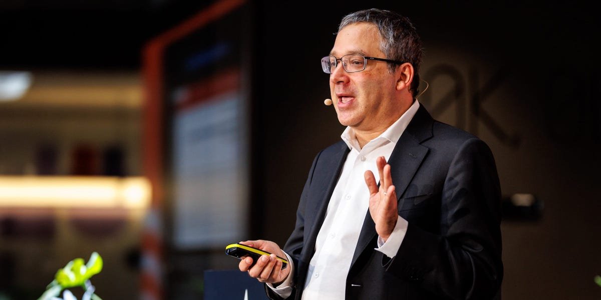 Portrait of Gary Marcus, a critic of AI hype, speaking at a conference.