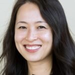A professional woman, representing a JPMorgan banker, in a sleek office setting, with subtle imagery of skincare products or financial charts in the background.