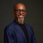 Portrait de Hamid Sidine, le nouveau Managing Director de Radisson Hotel Group pour le Maroc, souriant et professionnel.