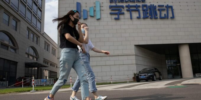 Hollywood industry figures reacting to a screen displaying AI-generated video, symbolizing the copyright and likeness concerns surrounding ByteDance's Seedance 2.0.