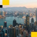 Hong Kong's Digital Horizon: Victory Fintech Secures Landmark Crypto License 4 A cityscape of Hong Kong, symbolizing its role as a financial hub, with a subtle overlay representing digital assets or blockchain technology.