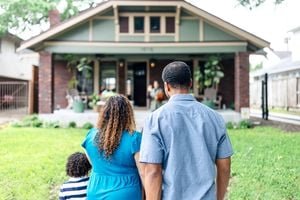 Unlocking Homeownership: How the 'Housing for the 21st Century Act' Aims to Tackle America's Affordability Crisis 9 A diverse group of people looking at a new house, symbolizing hope for affordable homeownership.