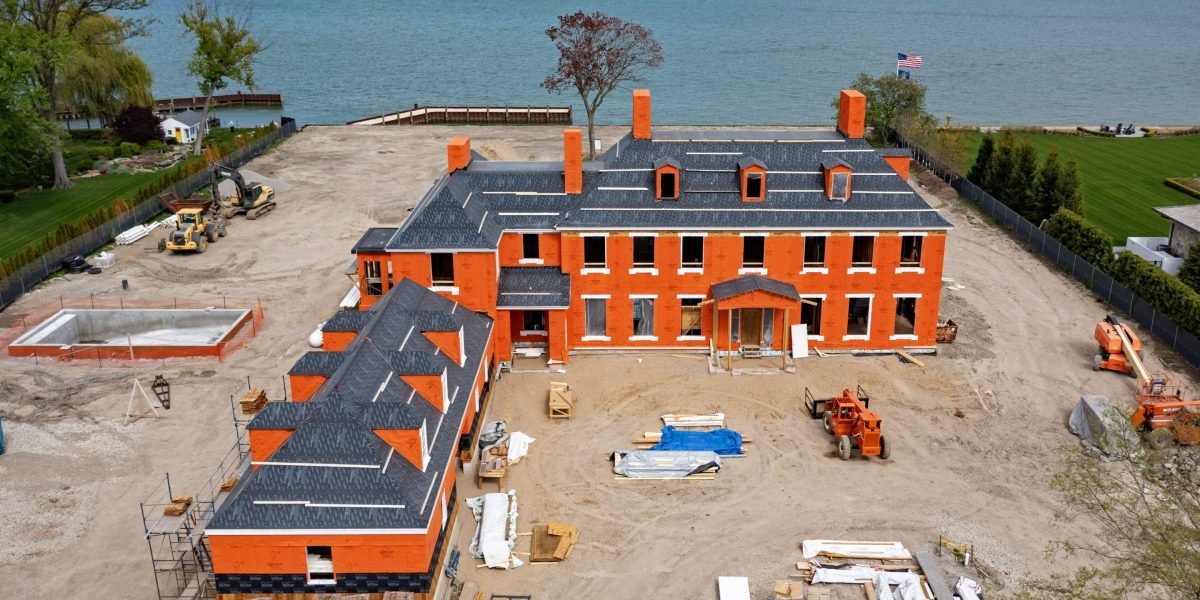 A modern cityscape at dusk, with residential buildings symbolizing the complex dynamics of the housing market and economic disparities.