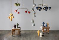 A multi-tier Bloom chandelier by Hwang Bishop, featuring cascading ceramic shades in soft matte glazes.