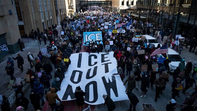 Federal Judge Upholds ICE Operations in Minnesota, Denies Emergency Halt Amid Protests 9 Protestors march with signs against ICE enforcement during a demonstration in Minneapolis, Minnesota.