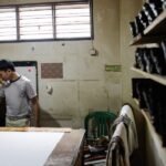 Indonesian textile factory with traditional batik fabric patterns in the foreground