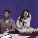 A founder shaking hands with an investor, with a blurred background suggesting a complex business deal and the importance of alignment.