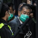 Media tycoon Jimmy Lai escorted by Hong Kong Correctional Services officers outside court