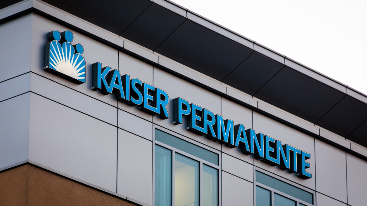 A smartphone displaying a text message with a 'STOP' button, symbolizing unwanted spam texts and a class-action settlement.