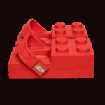 A pair of bright yellow LEGO Crocs with a LEGO minifigure, showcasing their blocky, exaggerated design.