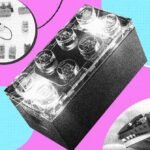 A close-up of Lego's new Smart Brick, a small black 2x4 brick, surrounded by various Star Wars Lego sets like the Millennium Falcon and a TIE fighter, showcasing interactive play.