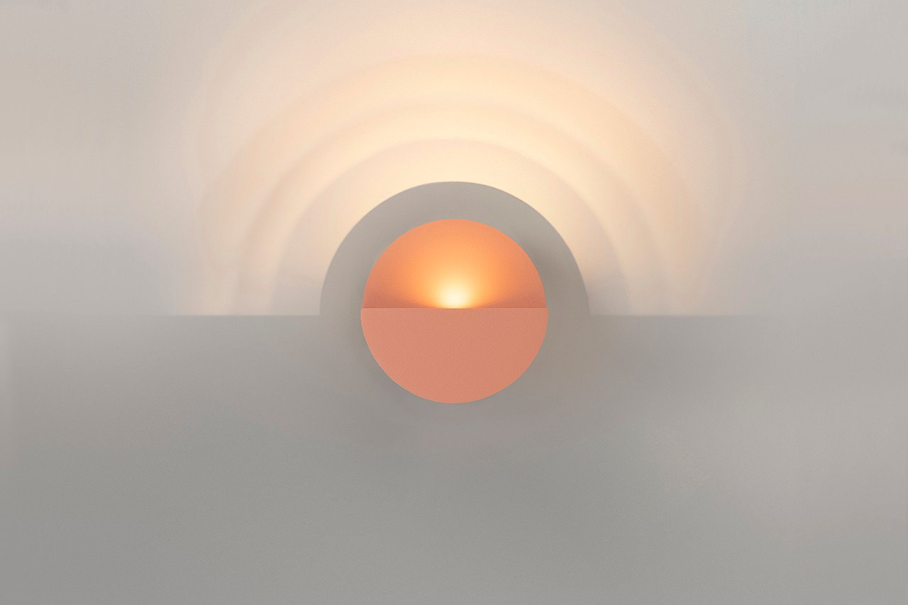 Maarten De Ceulaer's Impulse Collection light fixture casting layered shadows on a wall.