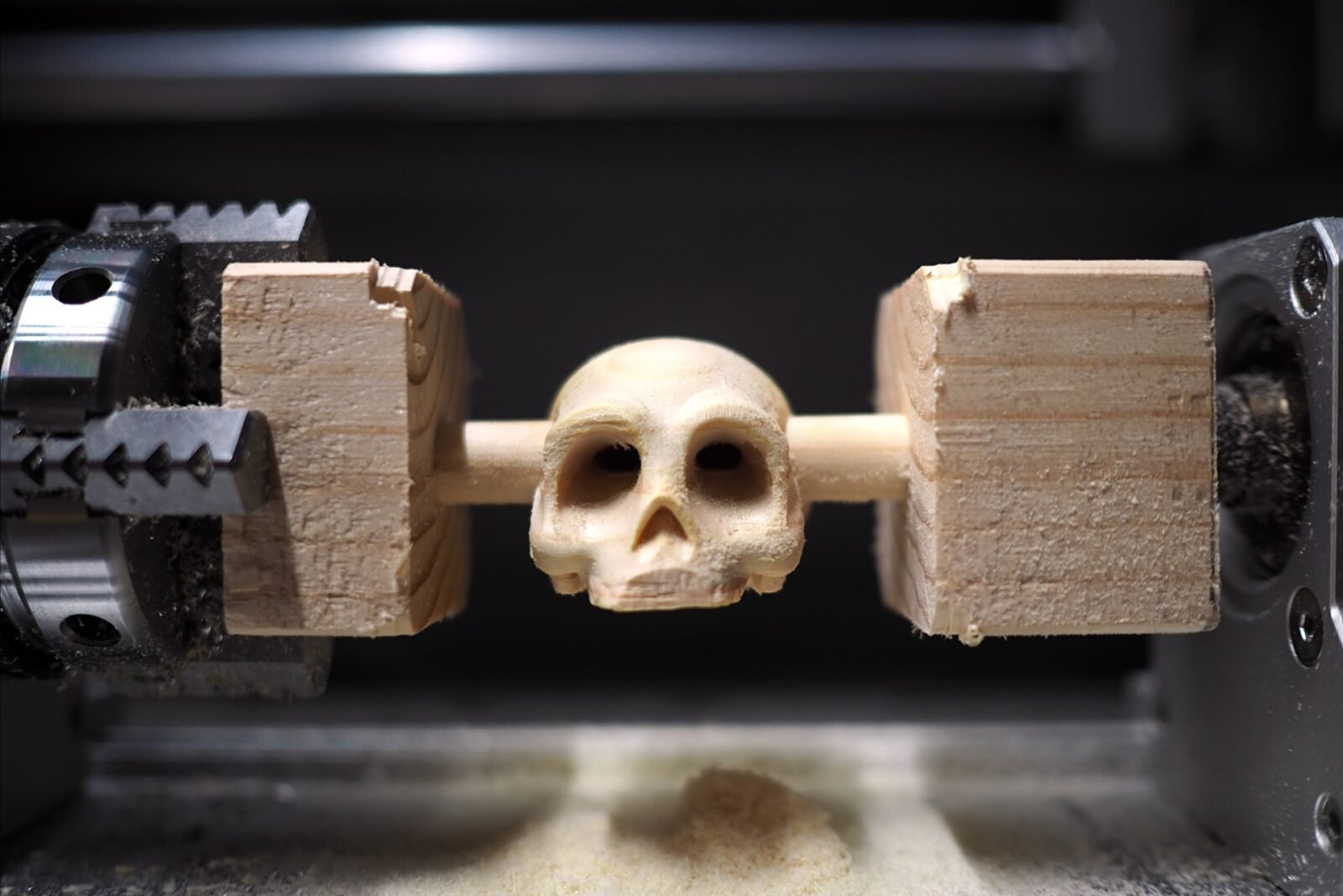 A Makera Carvera Air CNC machine carving a detailed skull model.