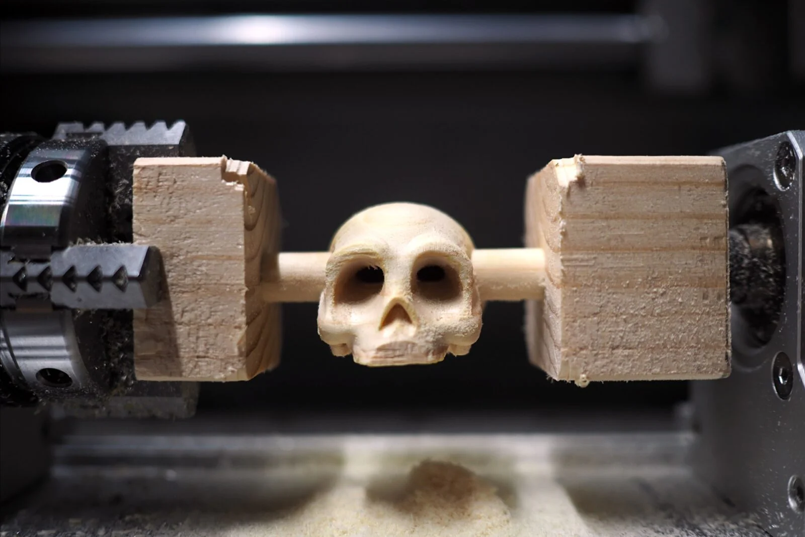 A Makera Carvera Air CNC machine carving a detailed skull model.
