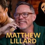 Matthew Lillard smiling during an interview, hinting at his return to the Scream franchise.