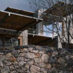 Meraki Studios: A Cretan Oasis Forged from Stone and Sun 4 Meraki Studios retreat nestled in the olive grove hills of Southern Crete, showcasing stone architecture and an infinity pool.