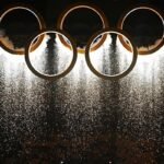 Panoramic view of San Siro Stadium during the Milan Cortina 2026 Winter Olympics Opening Ceremony with fireworks and athletes