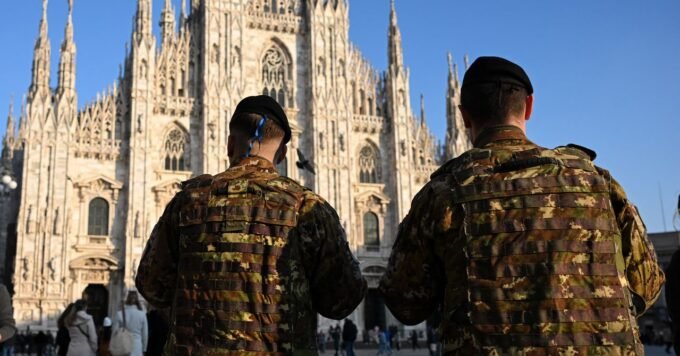 Qatari camouflage SUVs driving through Milan city center, part of the Olympic security apparatus.