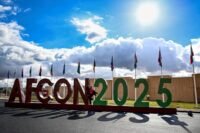 Aerial view of a modern football stadium in Morocco during AFCON 2025, symbolizing the tournament's economic impact and tourism boost.