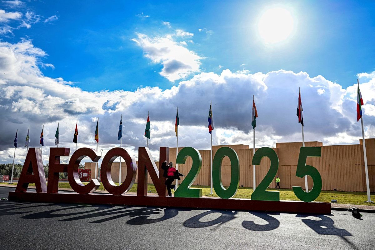 Aerial view of a modern football stadium in Morocco during AFCON 2025, symbolizing the tournament's economic impact and tourism boost.