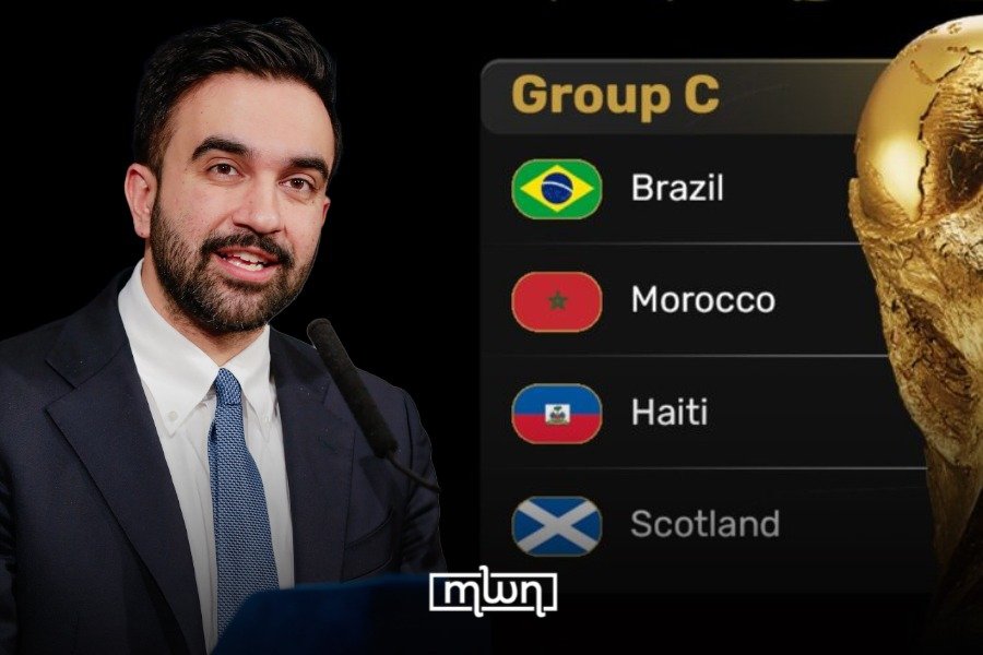 Zohran Mamdani speaking at a press conference, with a backdrop related to the FIFA World Cup 2026.