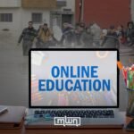 Moroccan students engaging in distance learning on laptops during flood displacement