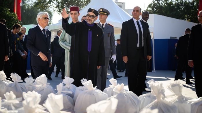 King Mohammed VI and Crown Prince Moulay El Hassan launching the Ramadan 1447 Solidarity Operation in Salé, Morocco, with food baskets and volunteers.