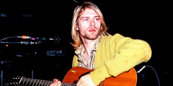A collage of diverse musicians, some with guitars, microphones, or on stage, representing artists who never had a No. 1 song.