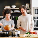 Various healthy foods and activities that contribute to lower blood pressure, such as a person exercising, meditating, and eating leafy greens.