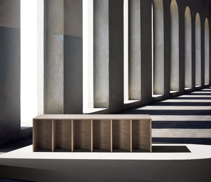 A sculptural installation featuring 'Layered Nature' wood veneers by nendo for ALPI, showcasing curved forms and delicate textures.