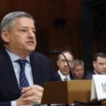 Netflix Co-CEO Ted Sarandos testifies before a Senate Judiciary Committee, flanked by Warner Bros. Discovery Chief Revenue and Strategy Officer Bruce Campbell, amidst a contentious hearing.