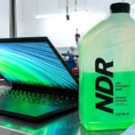 Demystifying Network Threats: A Journalist's Deep Dive into NDR Systems 2 A journalist working at a computer, with network diagrams and cybersecurity alerts on screen, representing a hands-on experience with an NDR system.