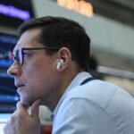 Nvidia's Moment of Truth: A $4.7 Trillion Bet on the Future of AI 4 A stock market ticker displaying Nvidia's stock performance with a backdrop of a bustling trading floor, symbolizing anticipation for earnings.