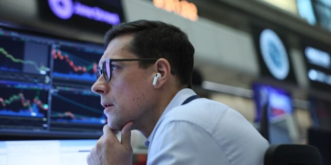 A stock market ticker displaying Nvidia's stock performance with a backdrop of a bustling trading floor, symbolizing anticipation for earnings.