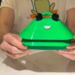 A collage of diverse open source hardware projects, including an industrial turntable car wash, a wearable haptic feedback belt, and a frog-shaped environmental sensor.